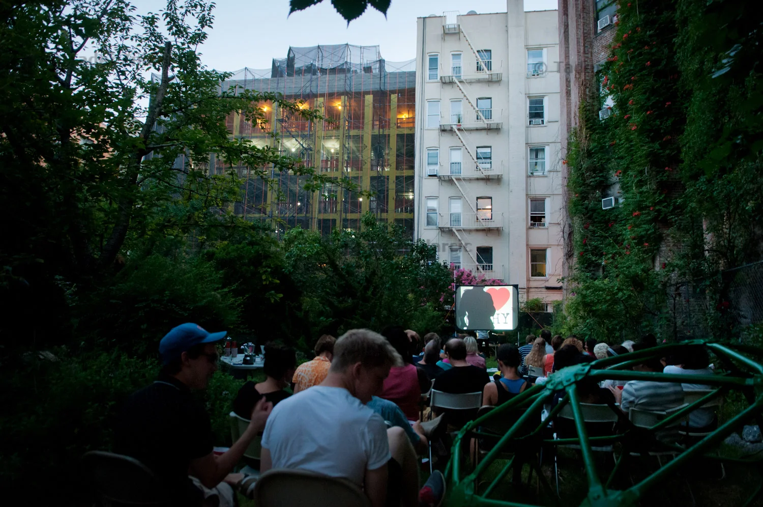 Spectators wait for the screening of a movie during annual MORUS film fest at Orchard Alley garden on E 4th street in East Village, NYC.