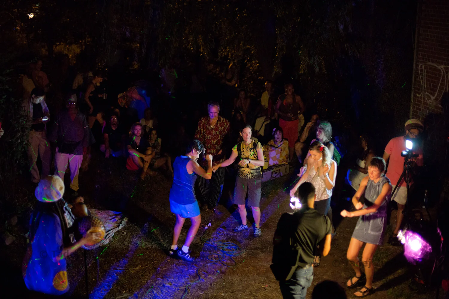 People dance and listen to the music by Peace Now Department during Blue Moon Festival at El Jardin del Paraiso on E 4th street in East Village, NYC.