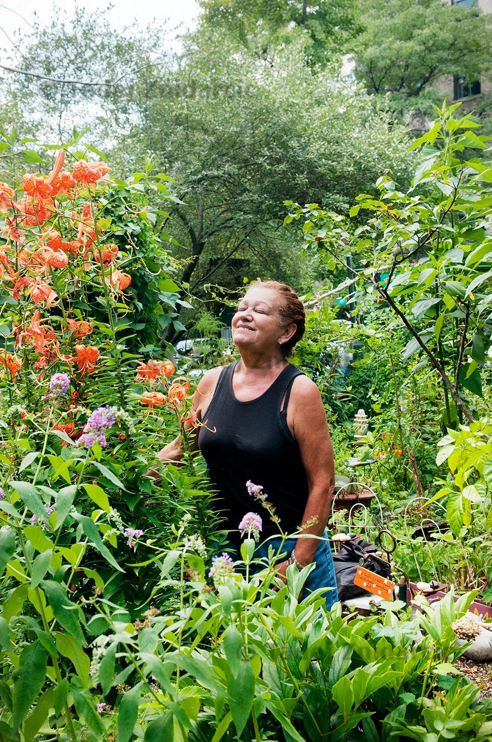 Marta Montanez stands in her garden in 9th Street Community Garden Plaza on 9th street and Avenue C in East Village, New York, USA.