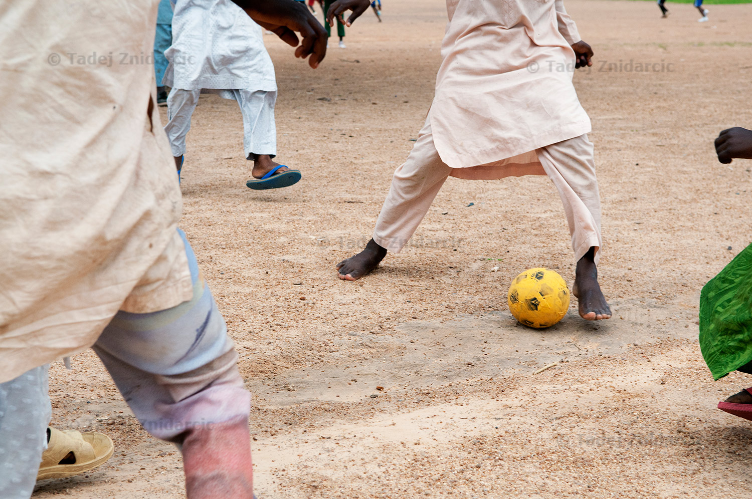 Boys play soccer in Tiga.