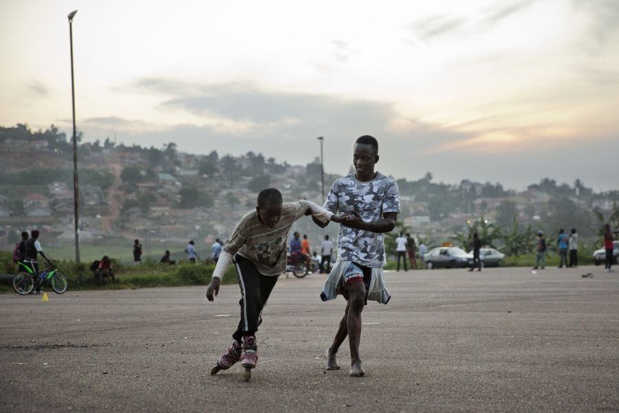 Peter helps a young skater at Mandela National Stadium.