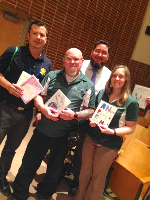 Left to Right - Brad Sweet (STEM program), Art Ross, Timm Green (STEM program), and Kristen Beltran holding student books.
