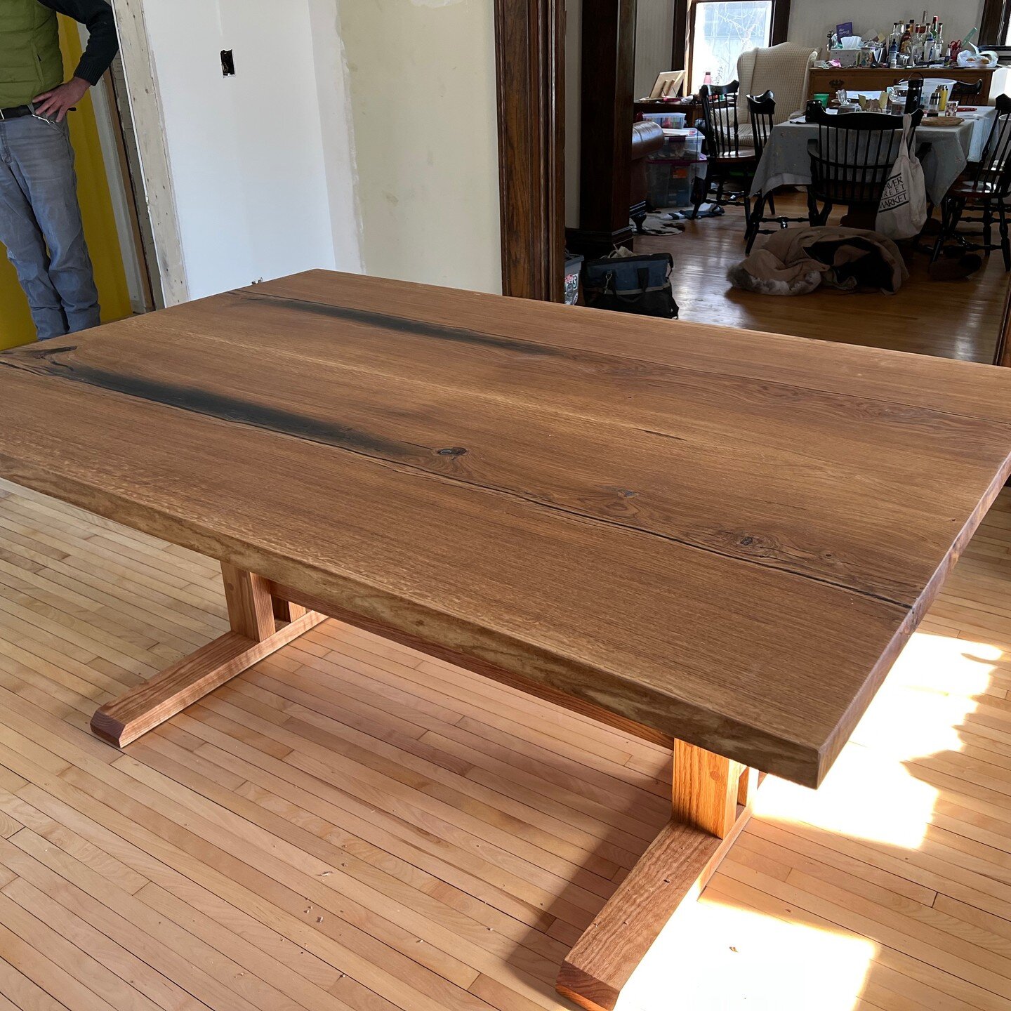 A nail was driven into this oak tree during its youth, and as the tree grew around the nail it rusted over time, creating the dark stain in the center of the tree. When we started working on this book-matched pair of slabs we did not know the extent 