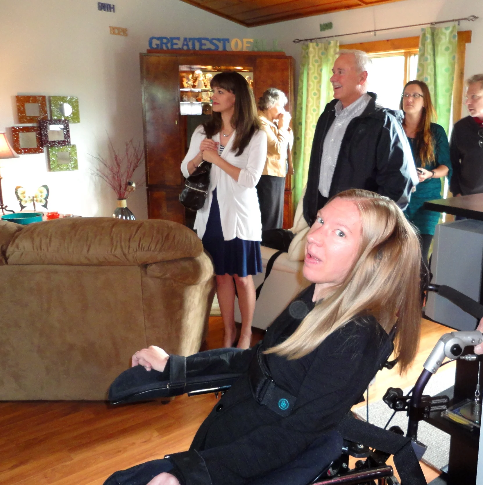   Sierra at home celebrating her home purchase with the people from the agencies that helped to make it possible  