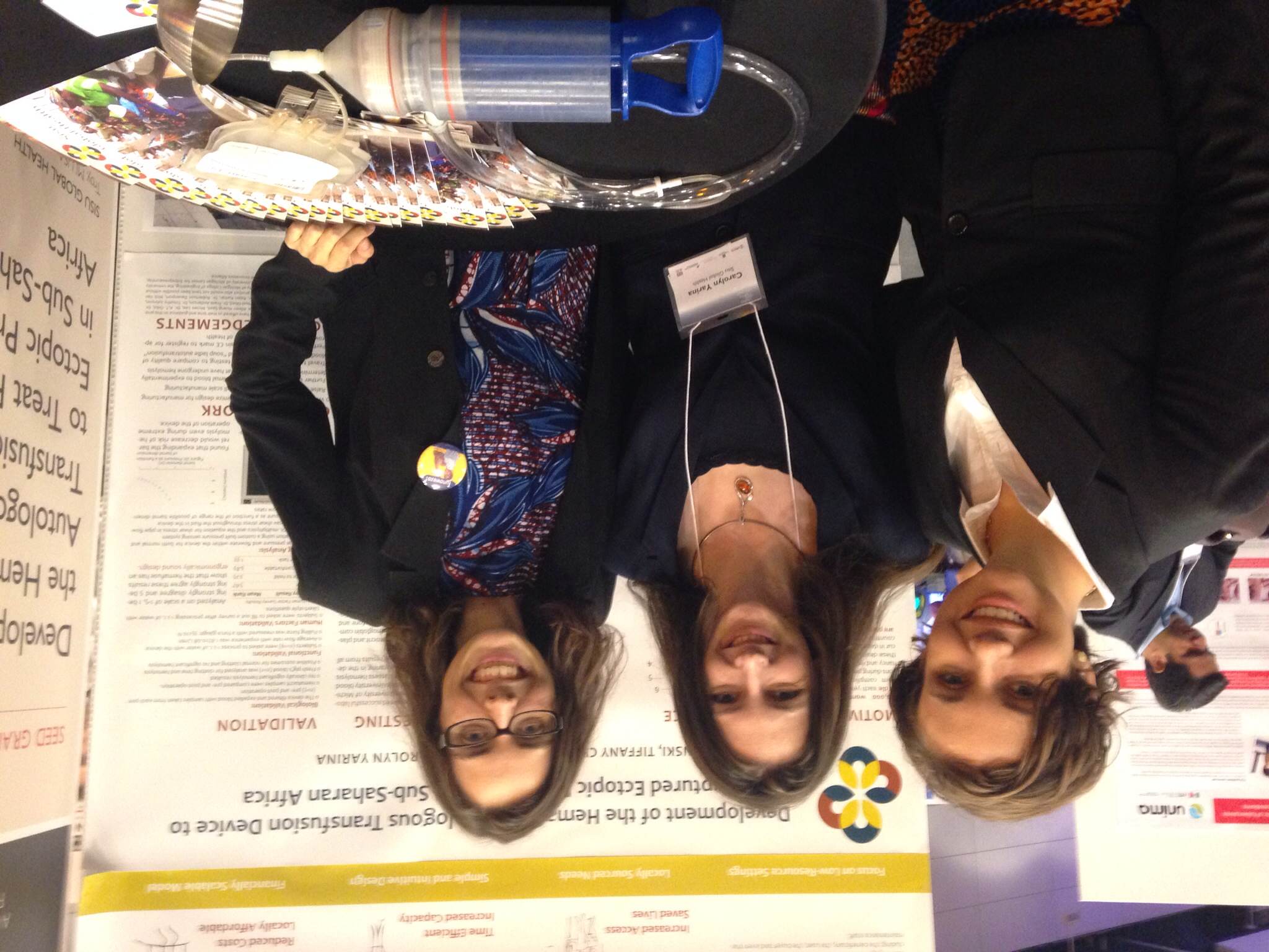 The Sisu Global Health team at the Saving Lives at Birth Development XChange. In the foreground, the Hemafuse is pictured next to another autotransfusion tool in Sub-Saharan Africa: the stainless steel soup ladle. 