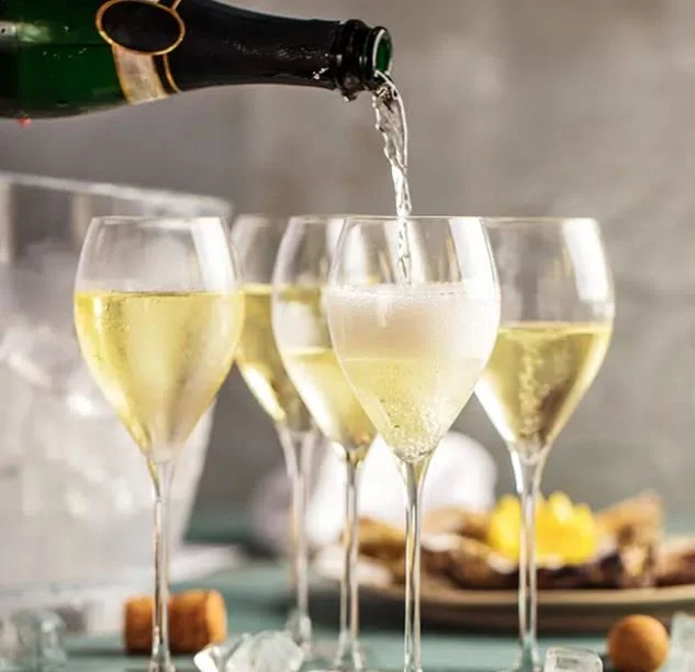 Sparkling wine in glasses pouring.JPG