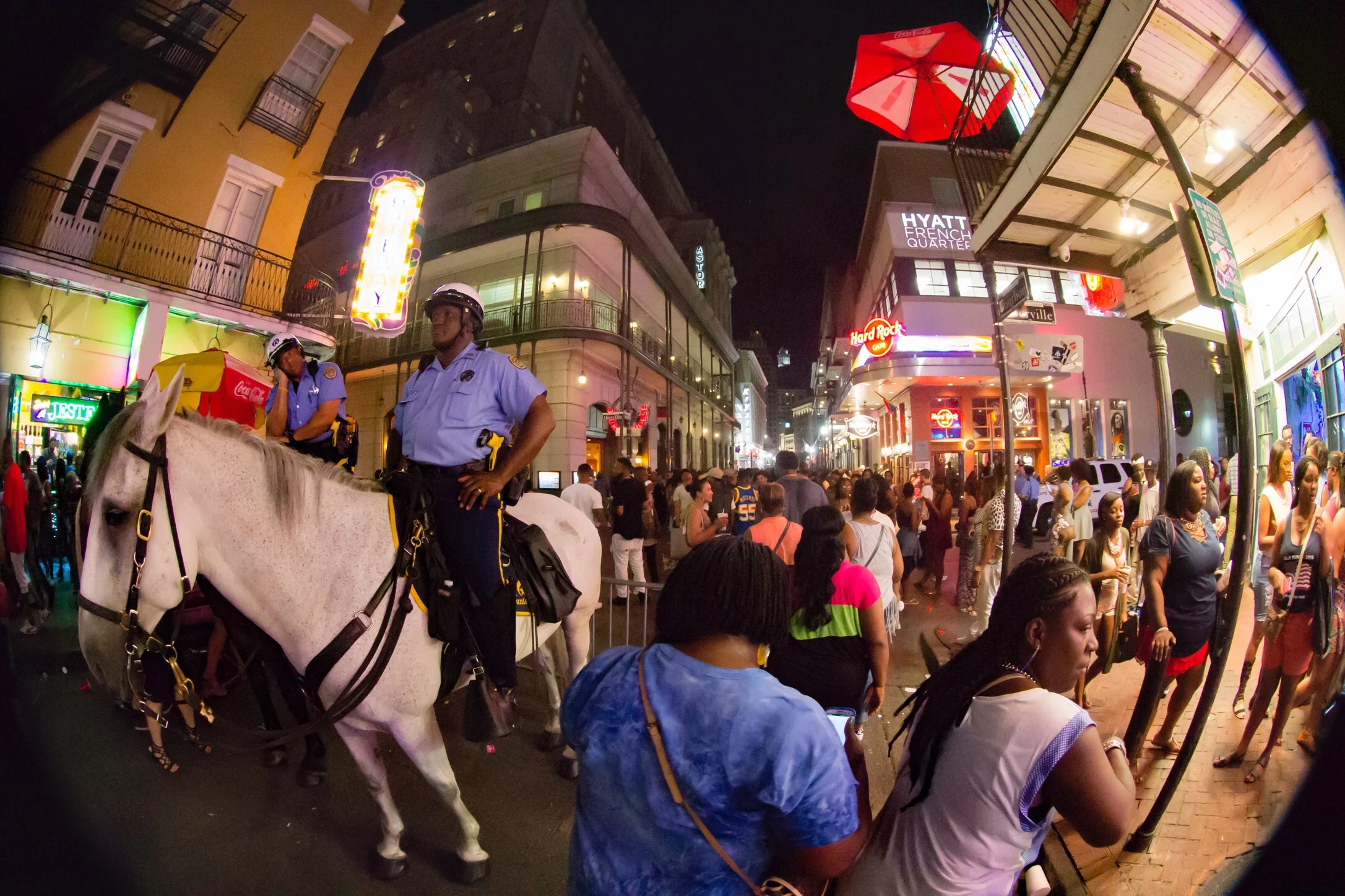 Mounted officers and party goers cross paths