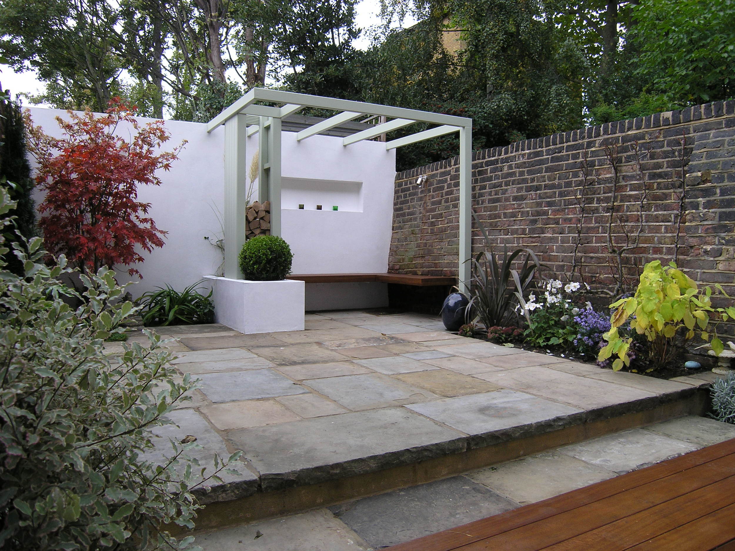 Low maintenance garden makeover in Islington with hardwood seating area