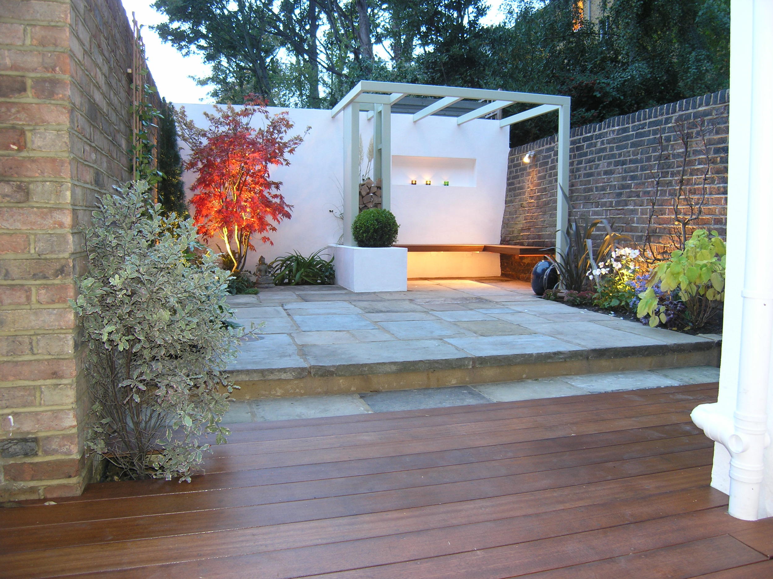 Modern garden design in N1 with hardwood decking and York stone patio