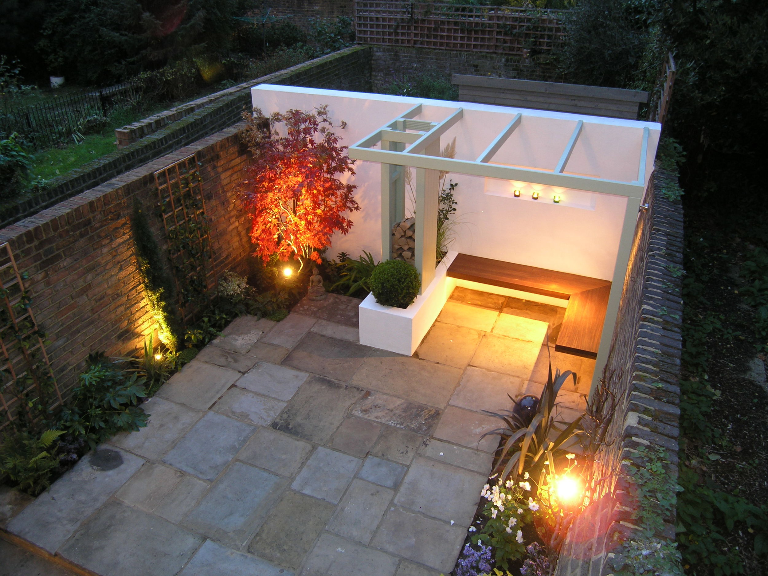 Evening in the Islington town garden with modern design and York stone patio