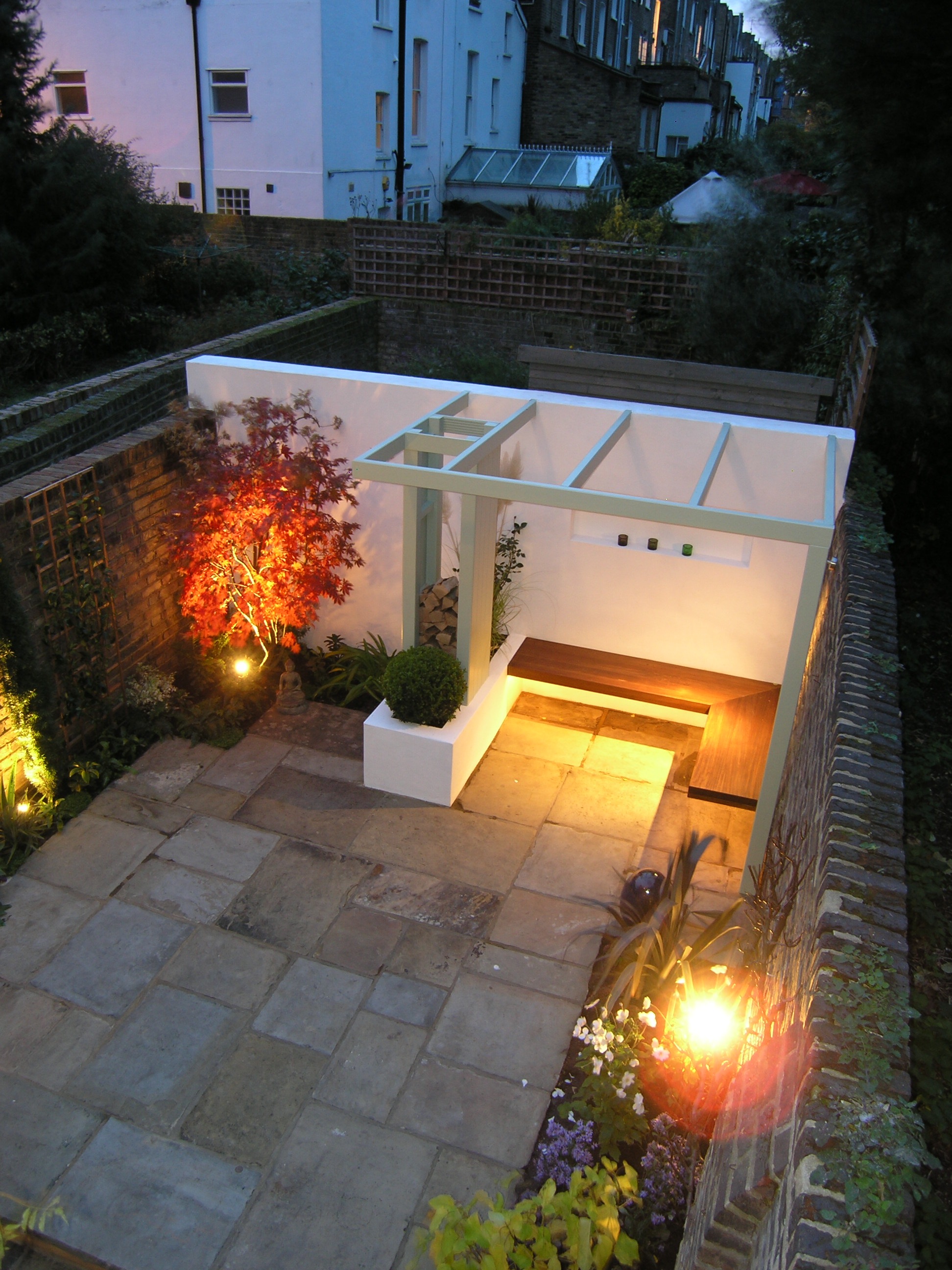 Garden design in N1 with bespoke outdoor seating area and York stone patio