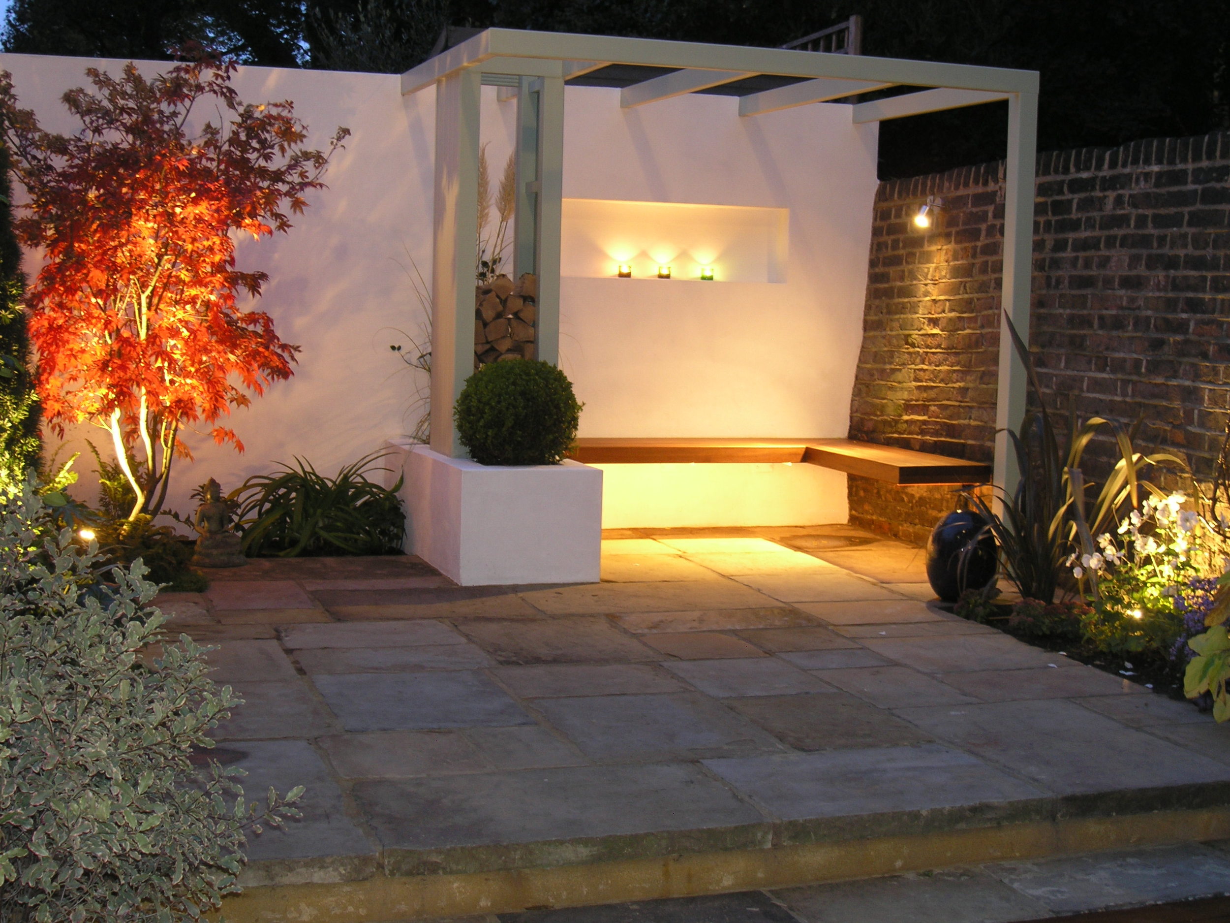 Bespoke garden design in N1 with Yorkstone patio and hardwood seating
