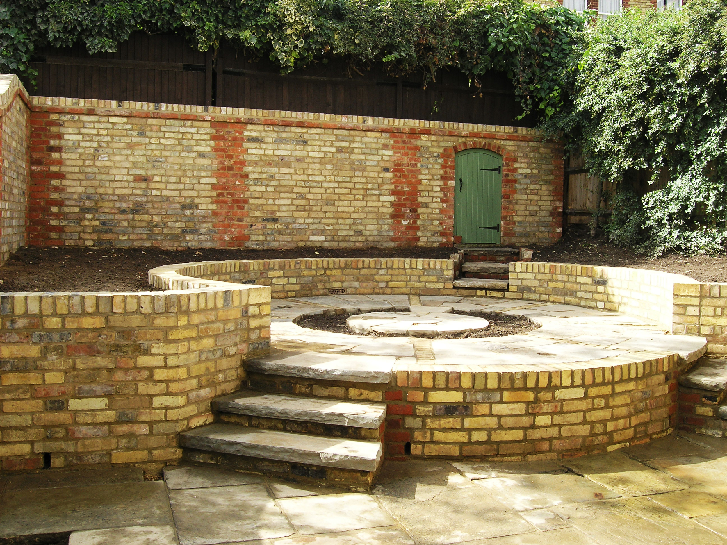 Courtyard garden ideas using reclaimed bricks in Highgate N6