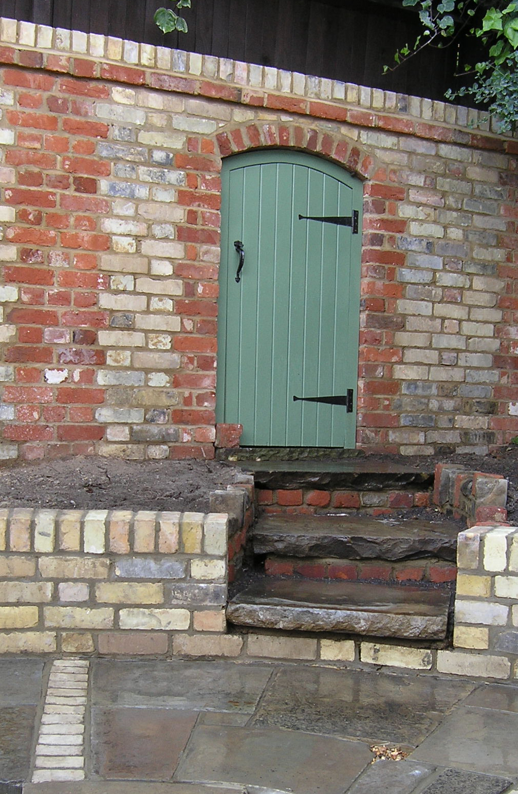 Traditional walled garden design with door in Highgate London