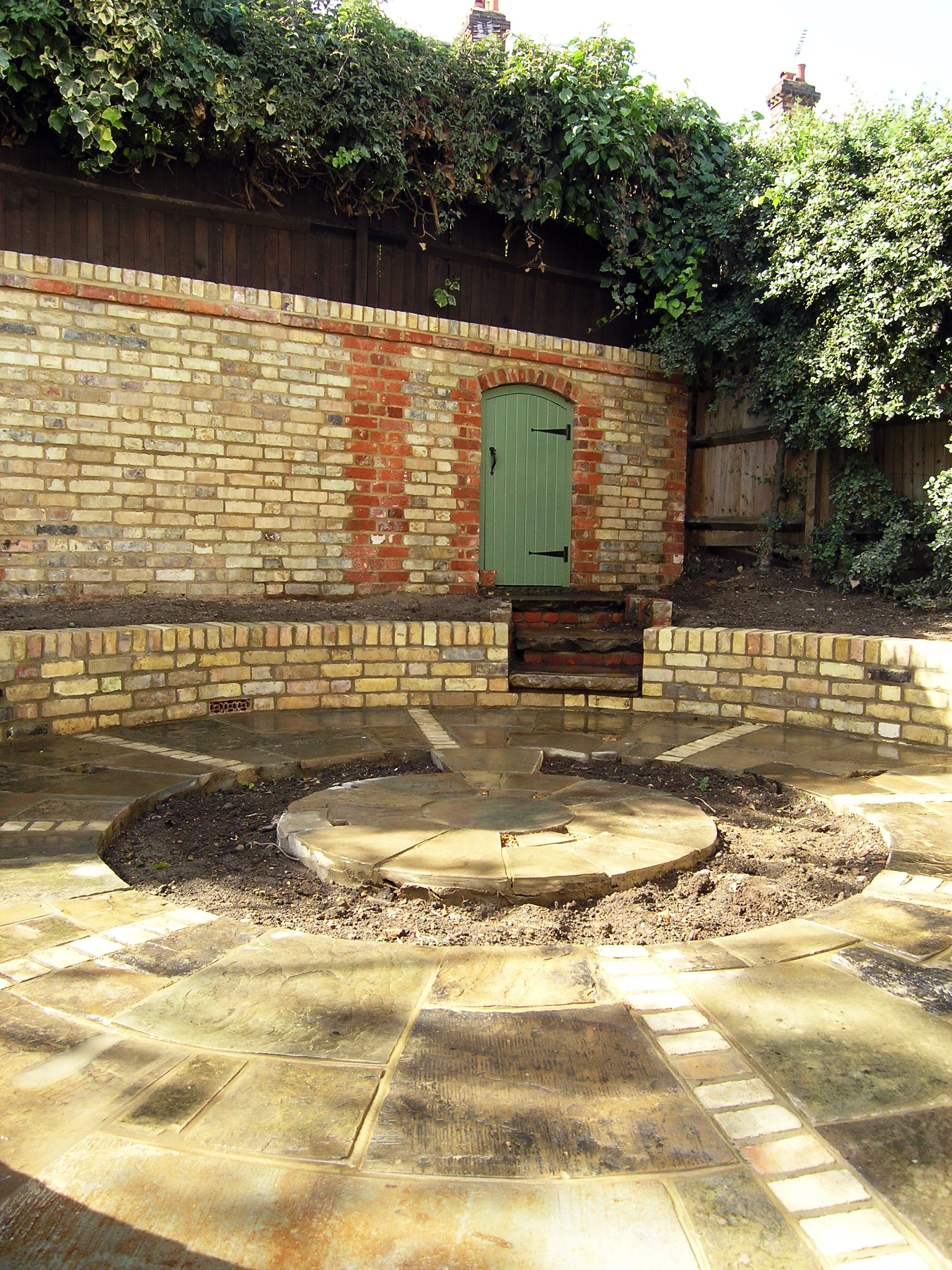 Traditional walled garden design with round beds in N6