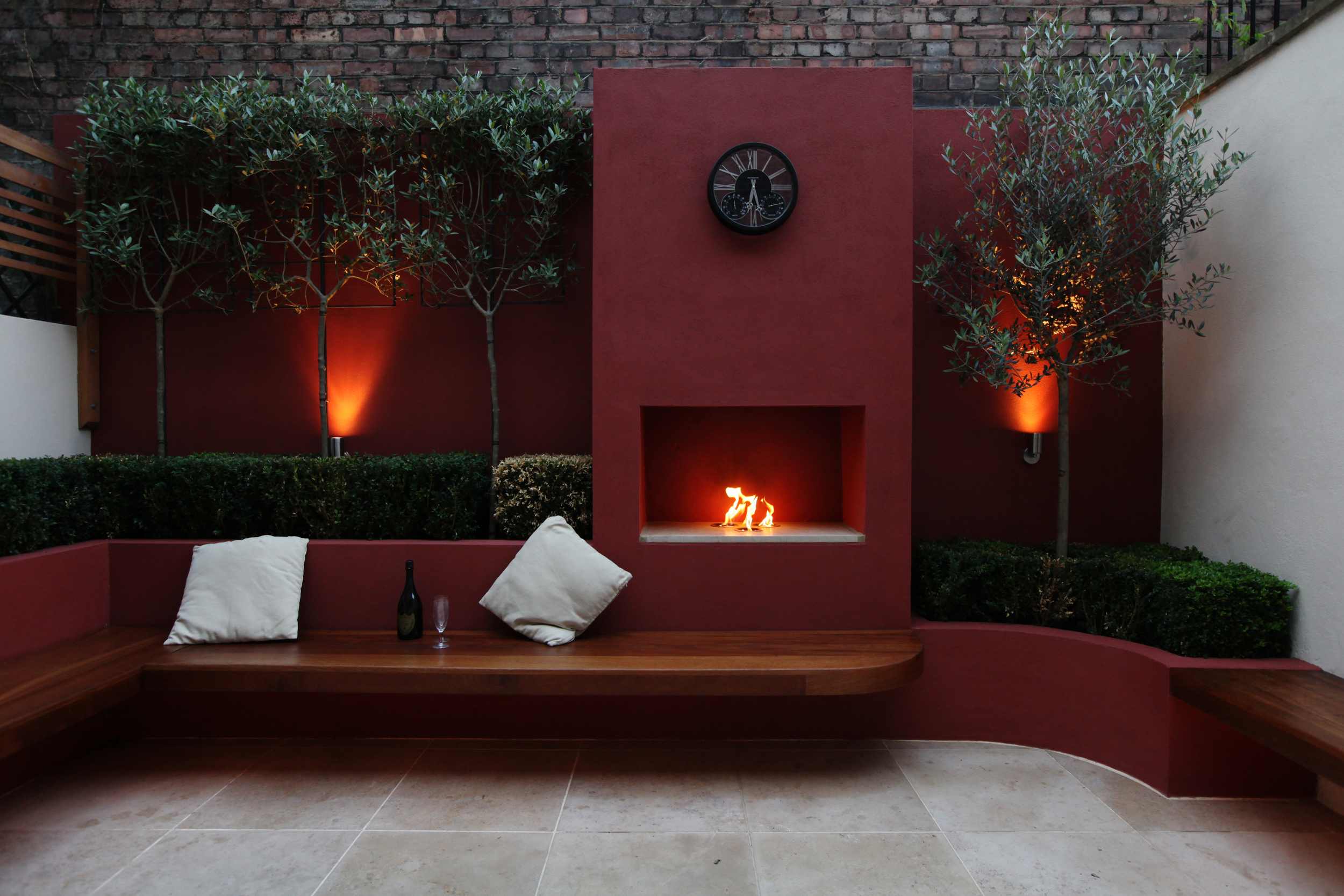 North London courtyard garden with lights, seating and a fire