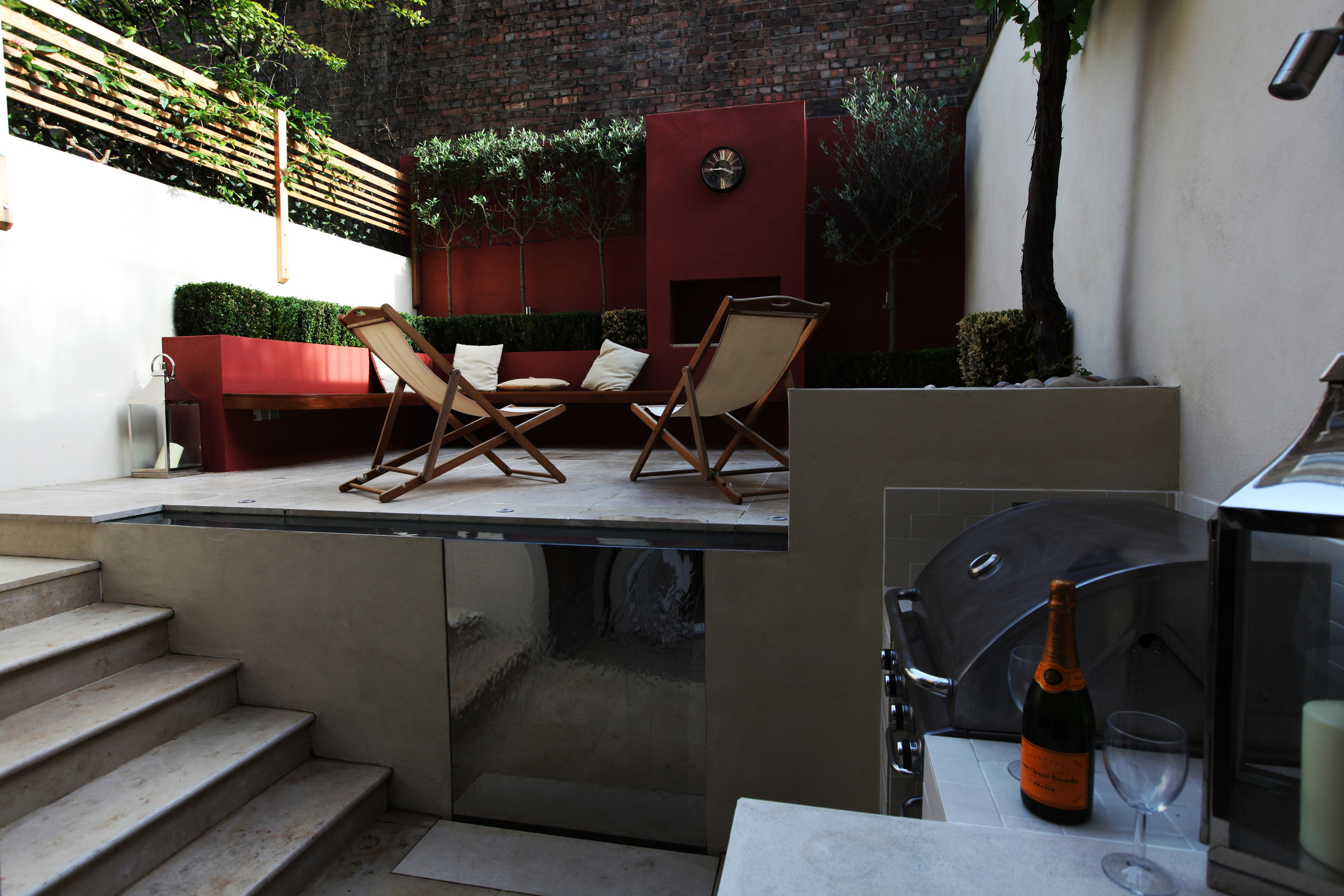 Islington courtyard garden redesign with outdoor kitchen and seating