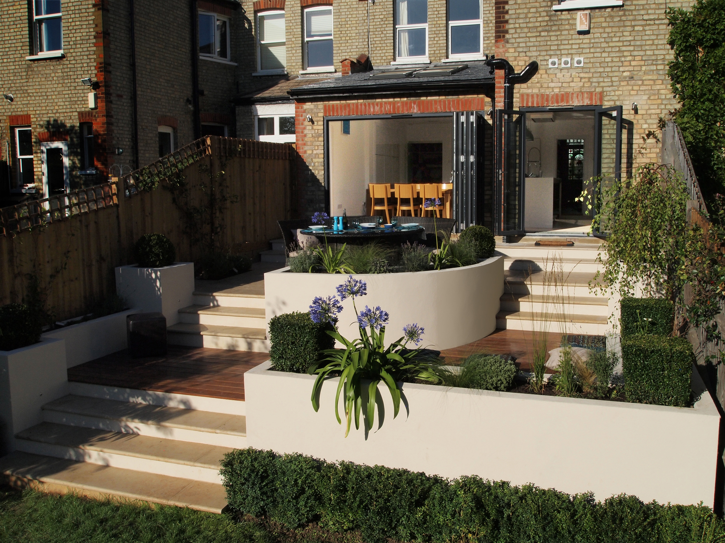 White planters frame this modern garden makeover in Muswell Hill N10