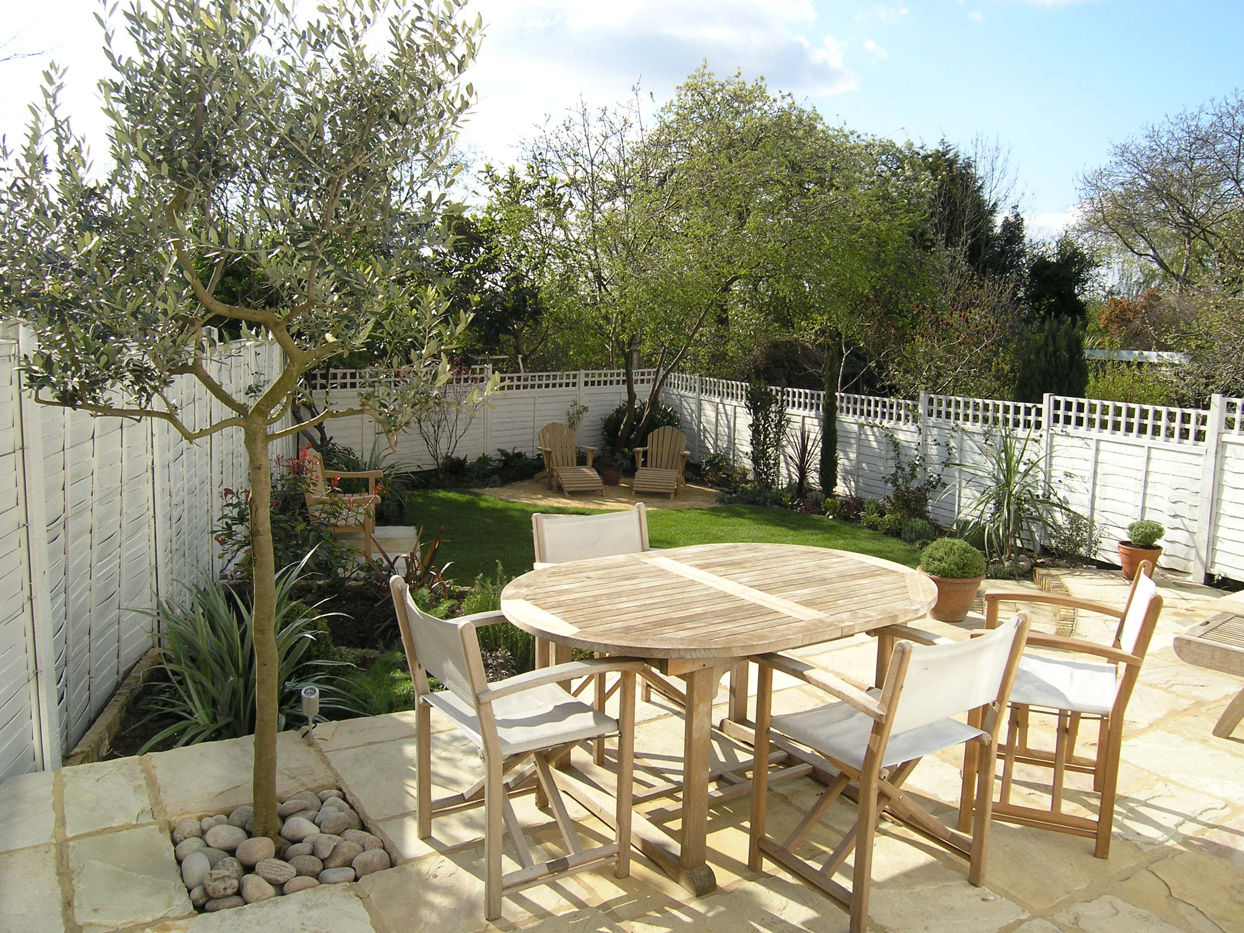 Sandstone dining area with Mediterranean planting in NW10 garden