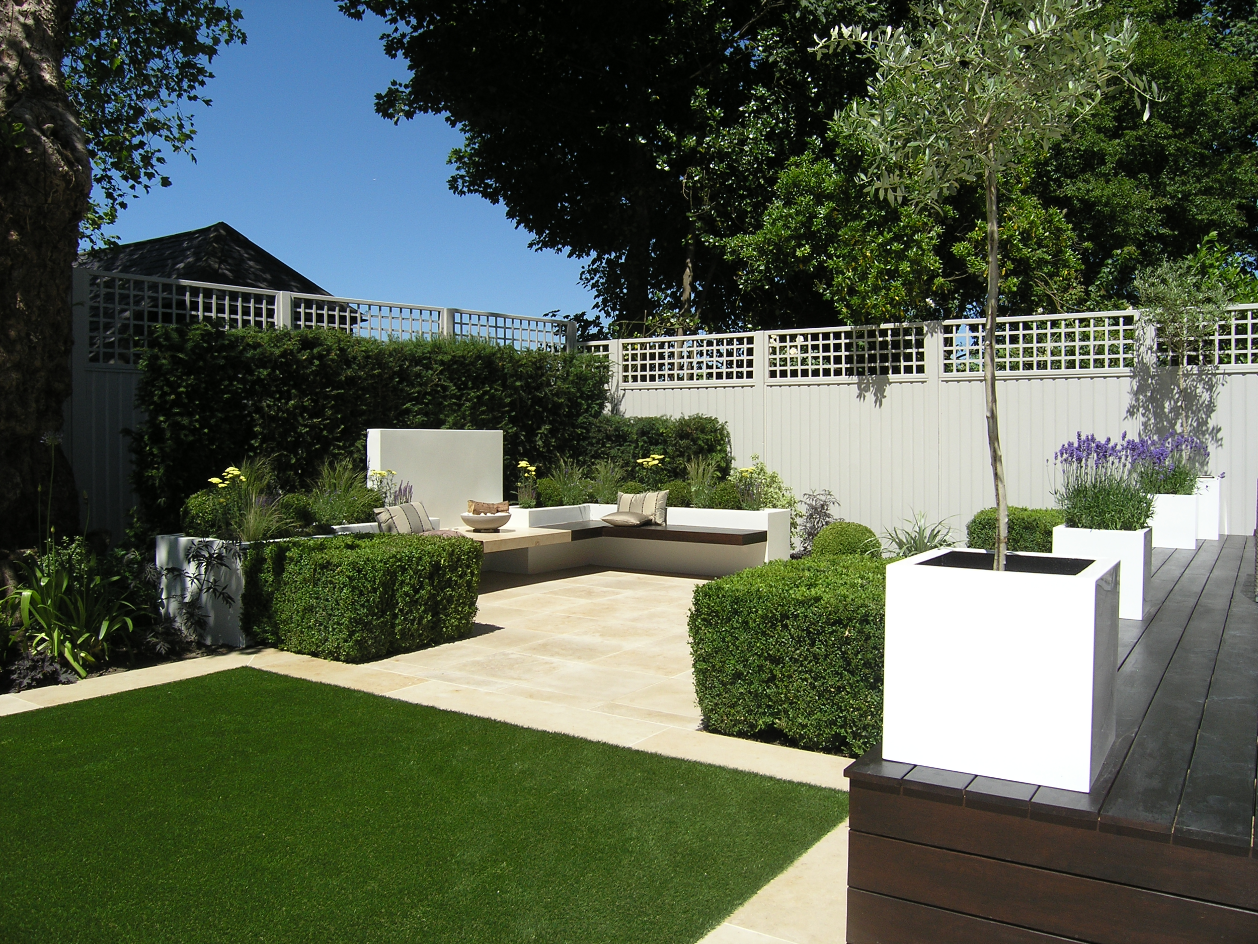 Limestone patio seating area with hedging in North London N6