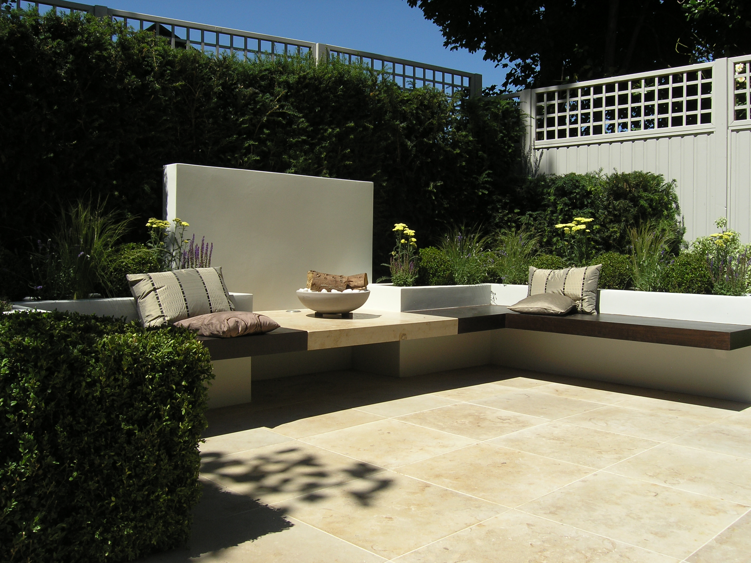 Limestone patio and seating area in garden makeover London N6
