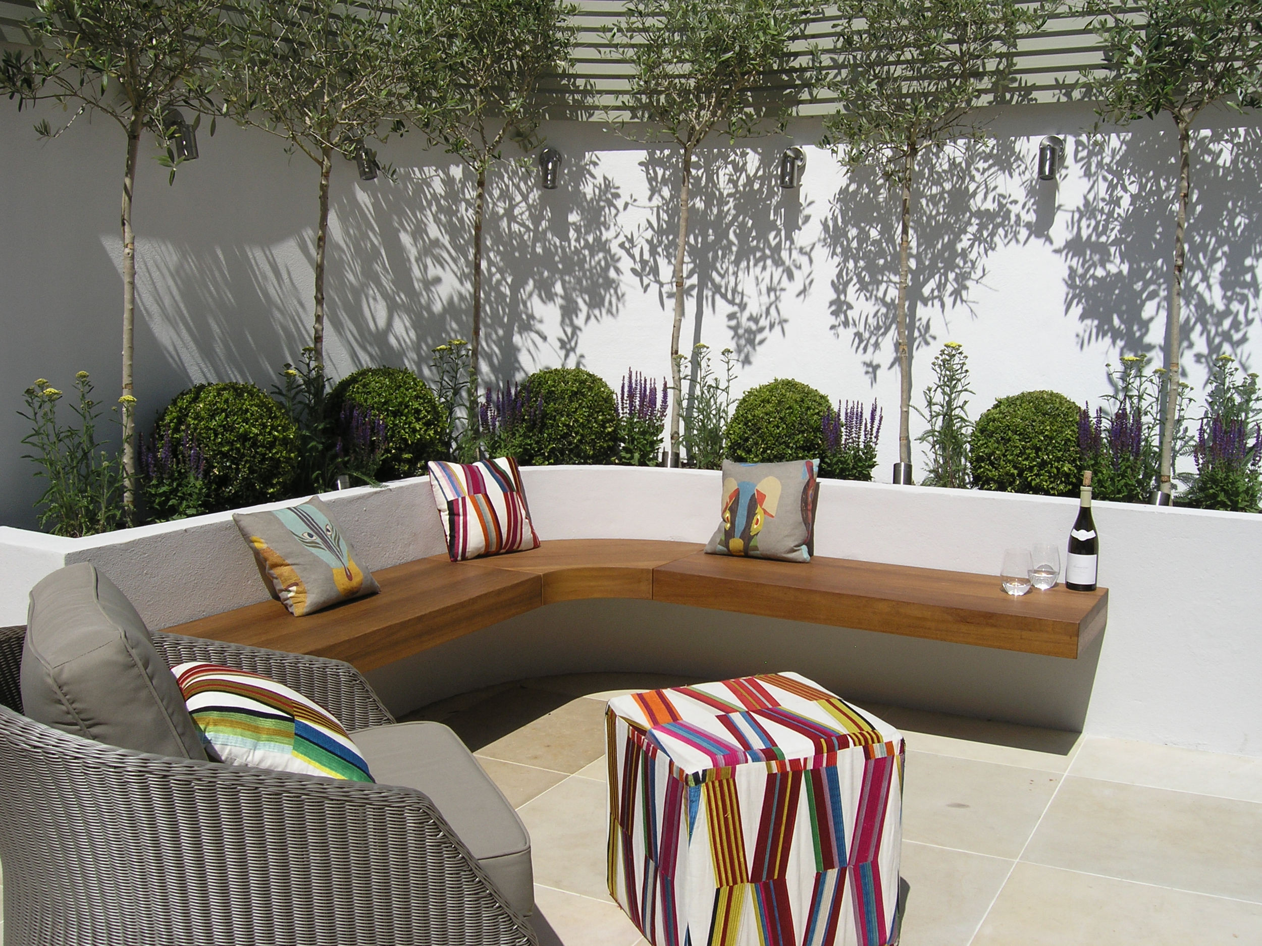 Small courtyard garden transformed by London landscapers in N8 with seating area