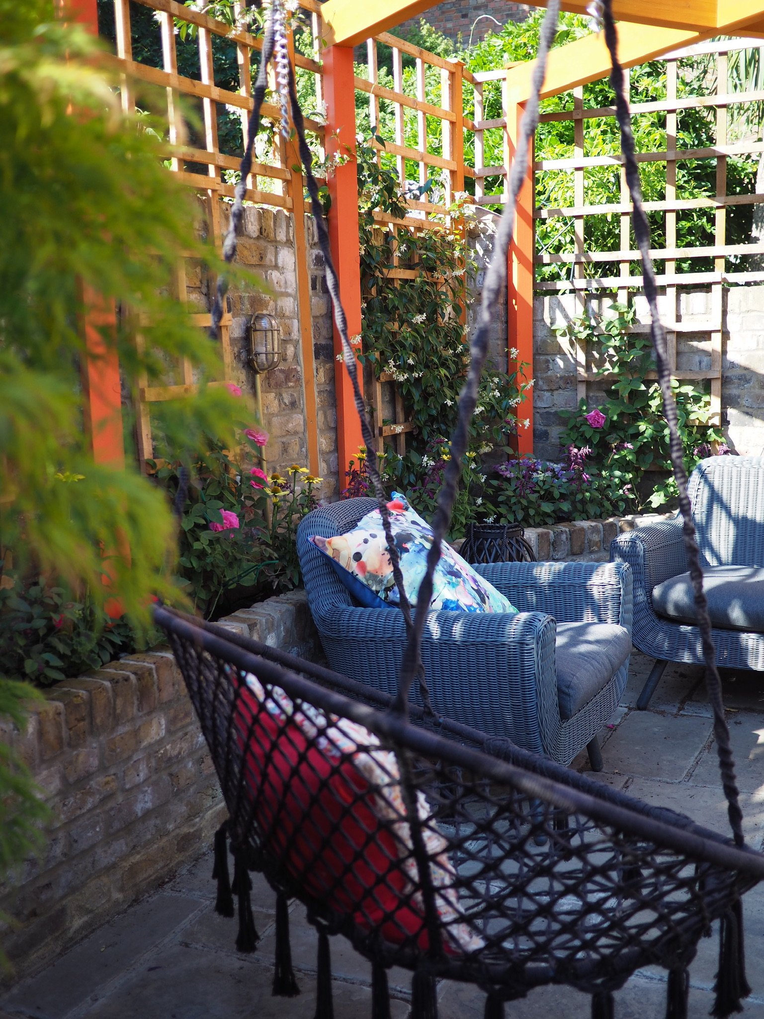 London landscape gardeners have created a family friendly garden with brick planters and seating area