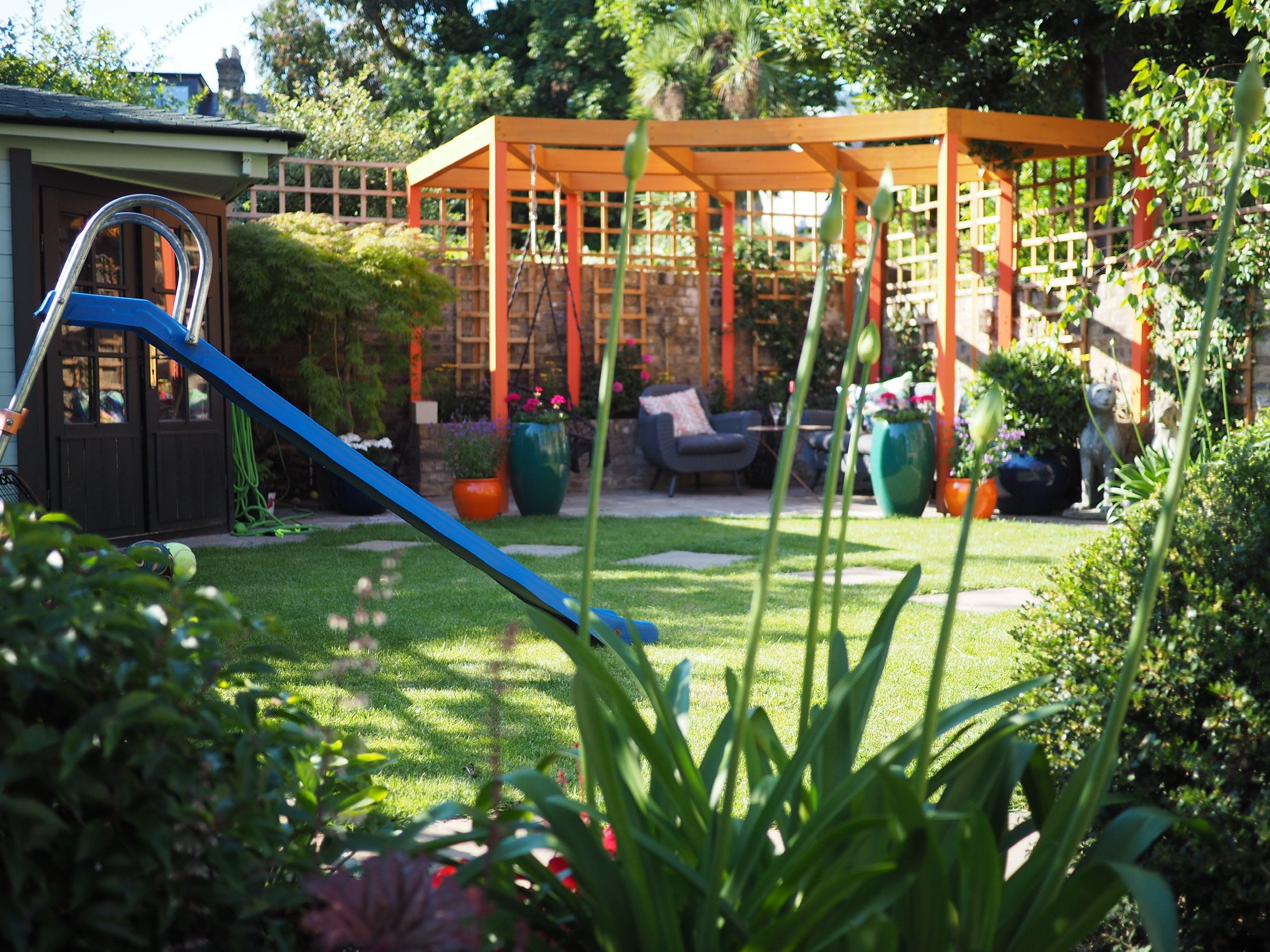 Islington garden landscaped for a family with slide and seating area