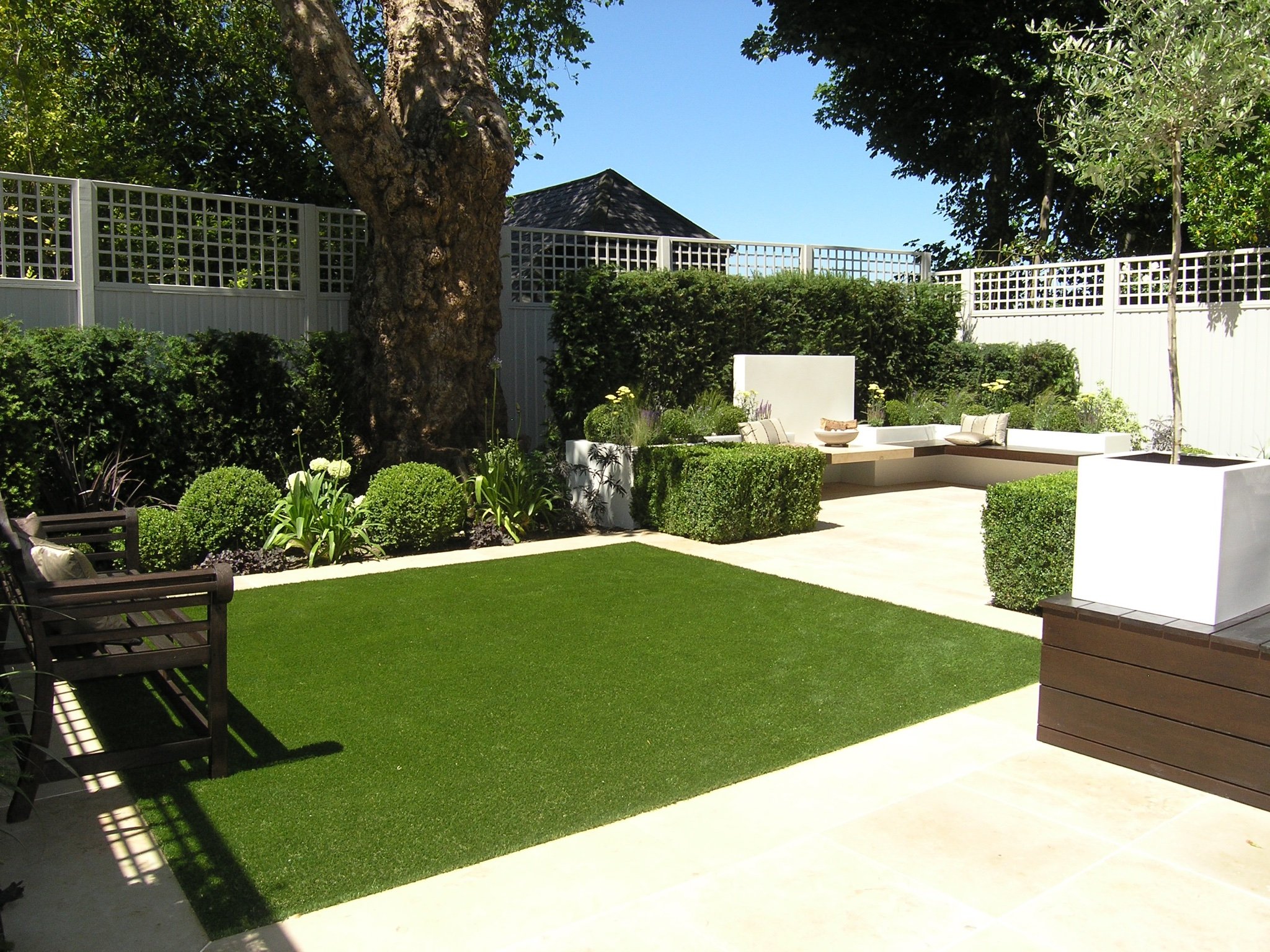 Modern garden design in North London N6 with outdoor rooms under a tree