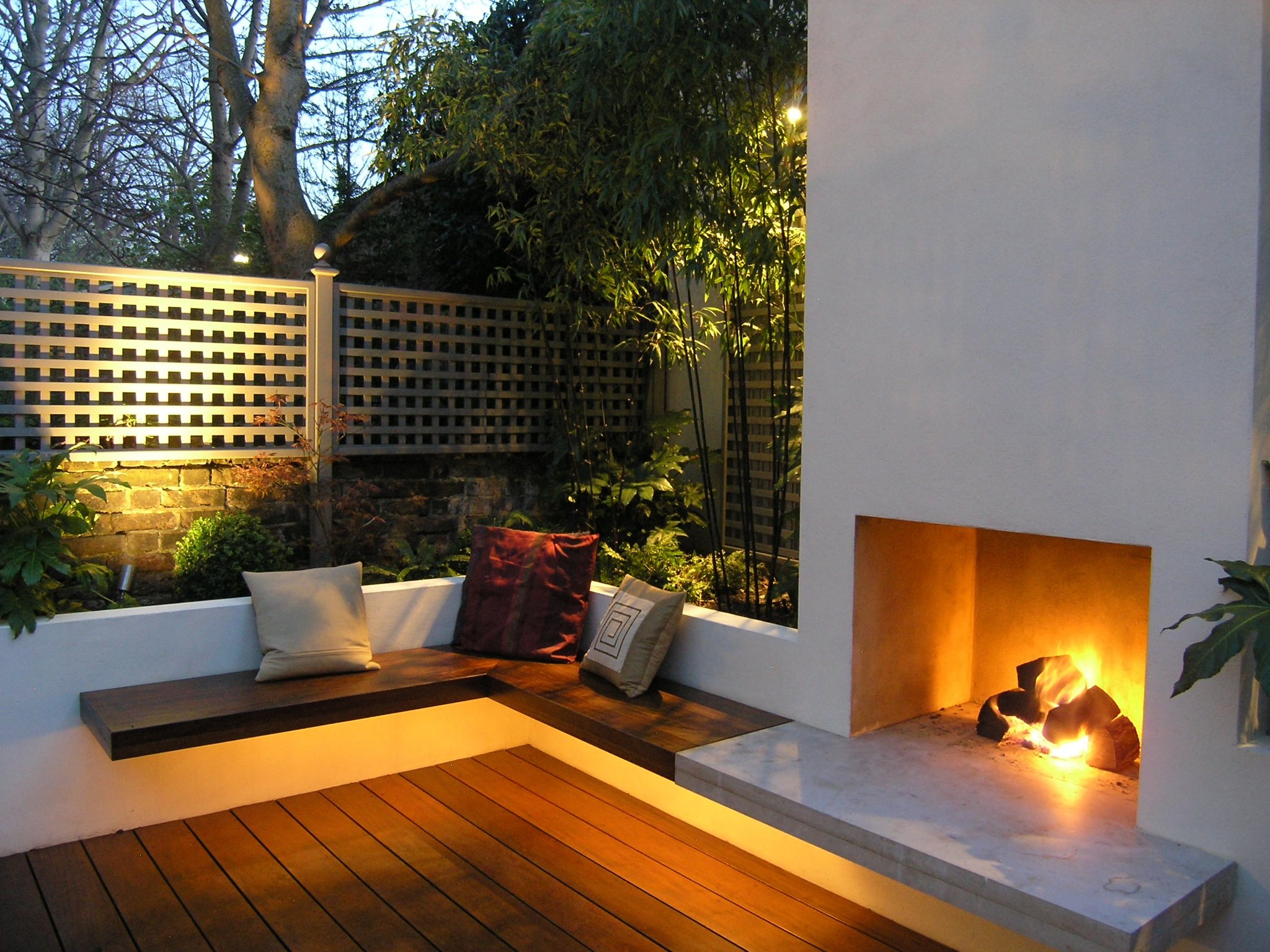 Seating area next to a fire in a North London landscaped garden