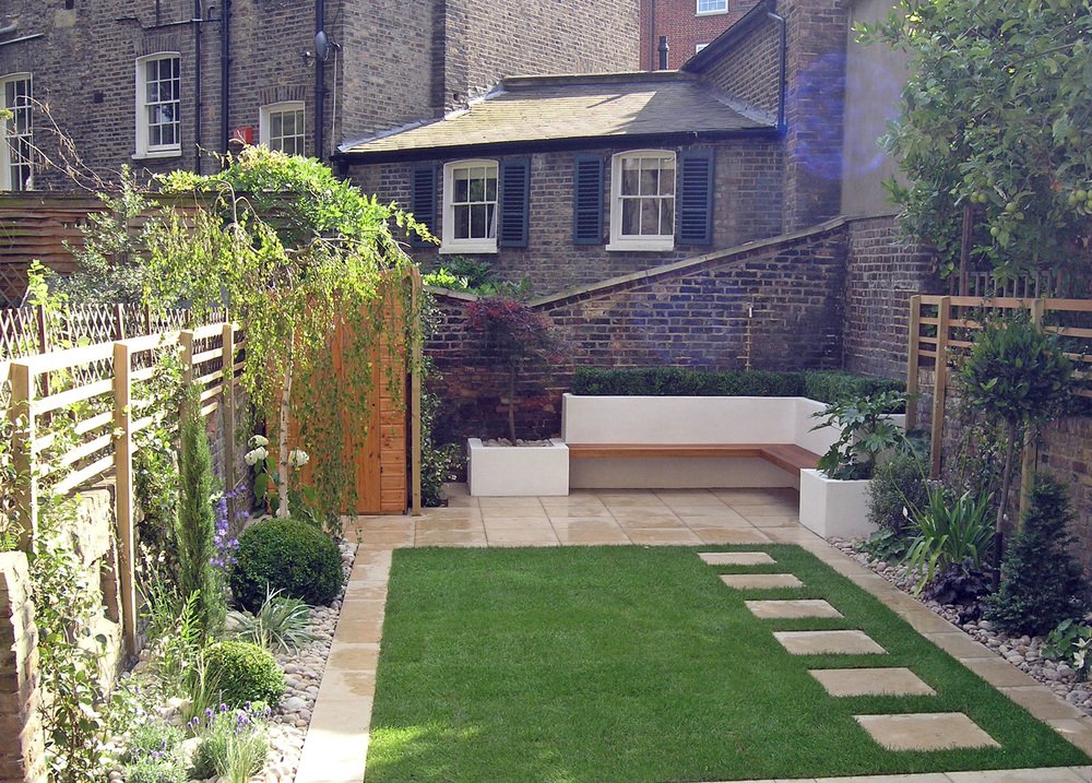  Modern garden design in Canonbury with contemporary light limestone paving and a spacious lawn. 