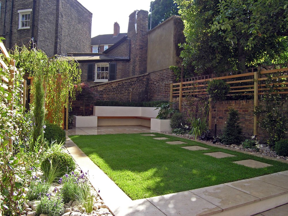  Contemporary garden design in N1 with borders flanking the lawn on either side with low maintenance structural planting and a limestone patio. 