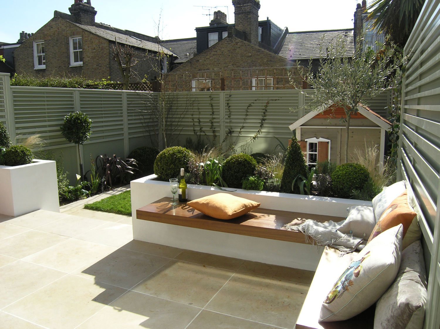  Square garden design in Clapham for family garden landscaping project with limestone patio and low maintenance lawn. 