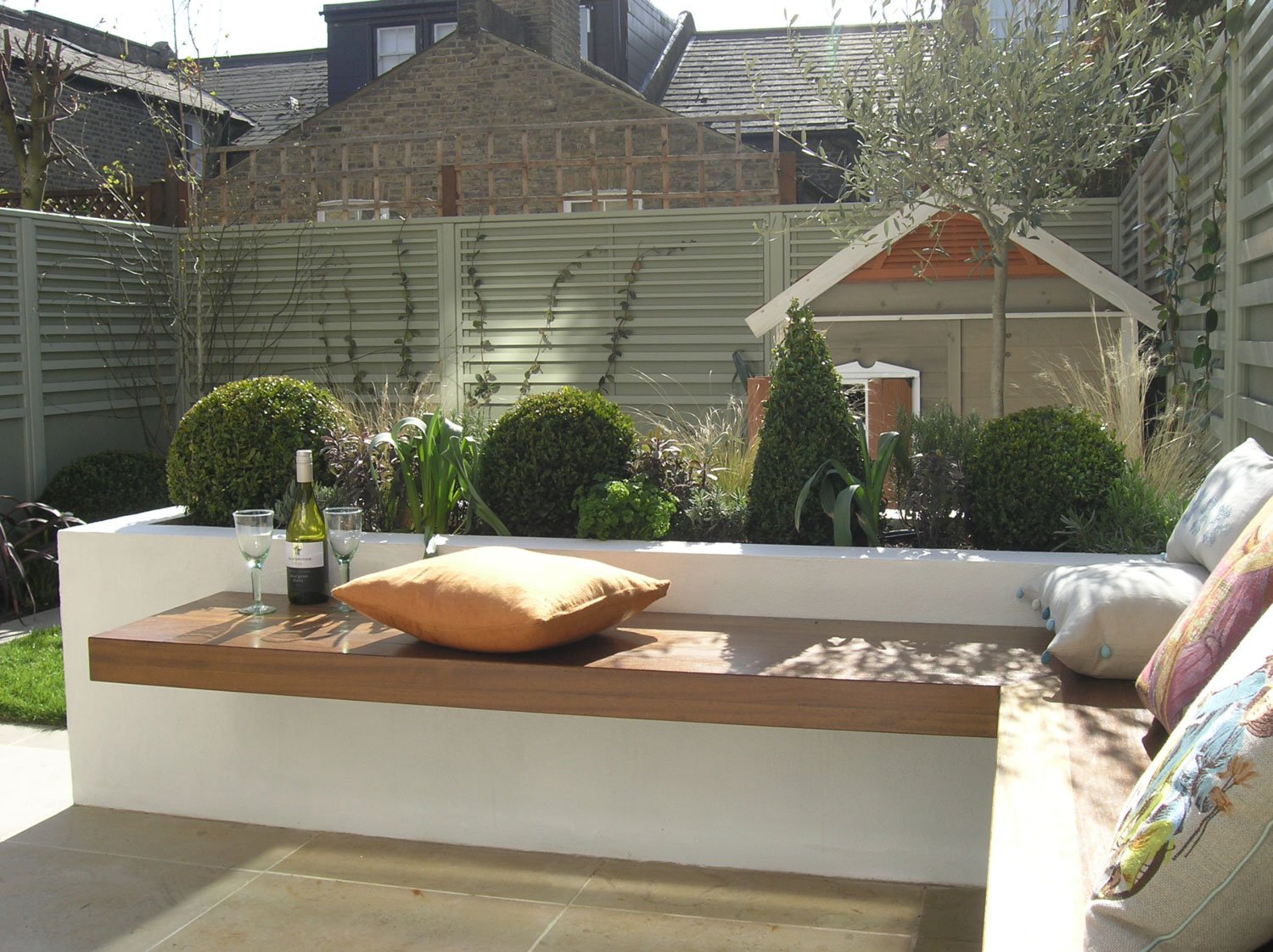  Bespoke seating area around patio in square garden design London 