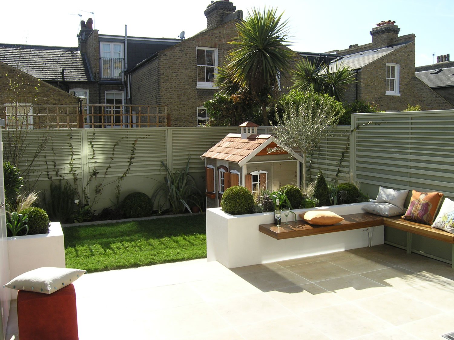  Square garden designs with patio seating and children's play house London. 