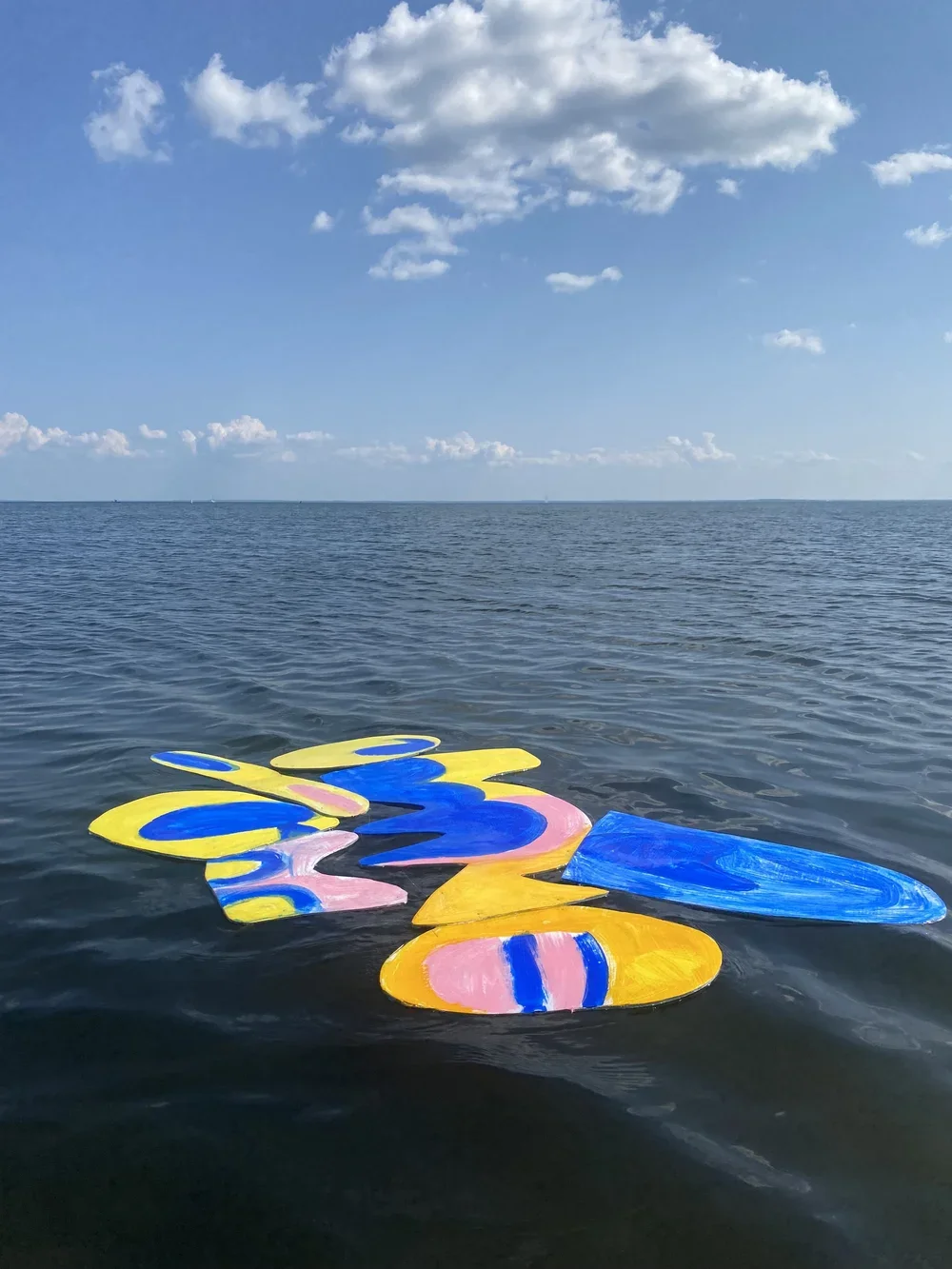 water with art colorful collage floating in the sea