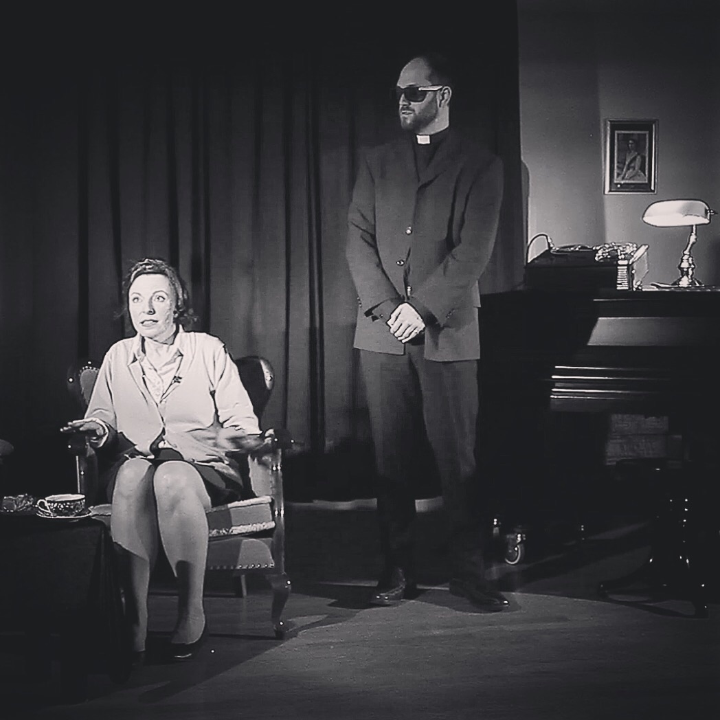 Tom during a scene as Reverend Dearborne
