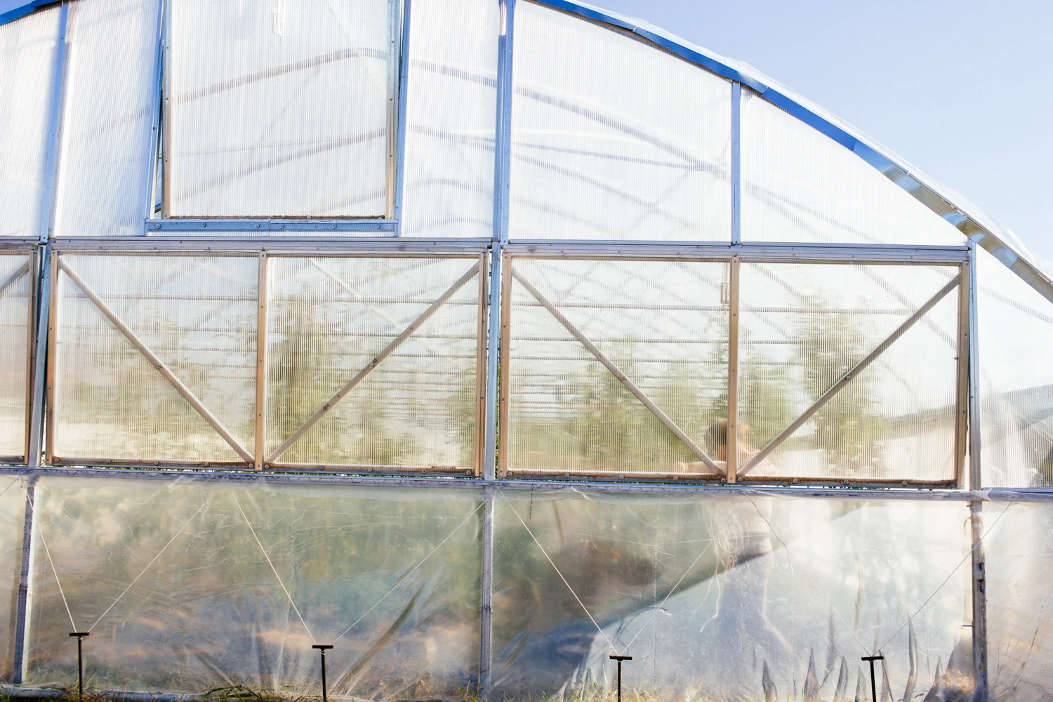 A worker at Doublebrook Farms maintaining a part of the moving greenhouse.