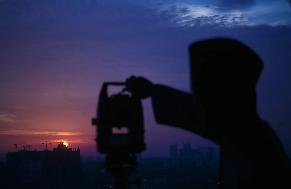 An officer of Malaysia's Islamic authority uses a telescope to perform “rukyah,” the sighting of the new moon of Ramadan, in Putrajaya, outside Kuala Lumpur, on June 5, 2016. Muslims scan the sky at dusk in the beginning of the lunar calendar's ninth month in search of the new moon to proclaim the start of Ramadan, Islam's holiest month during which observant believers fast from dawn to dusk. From The Atlantic, 'Images of Ramadan 2016. https://www.theatlantic.com/photo/2016/06/images-of-ramadan-2016/486212/