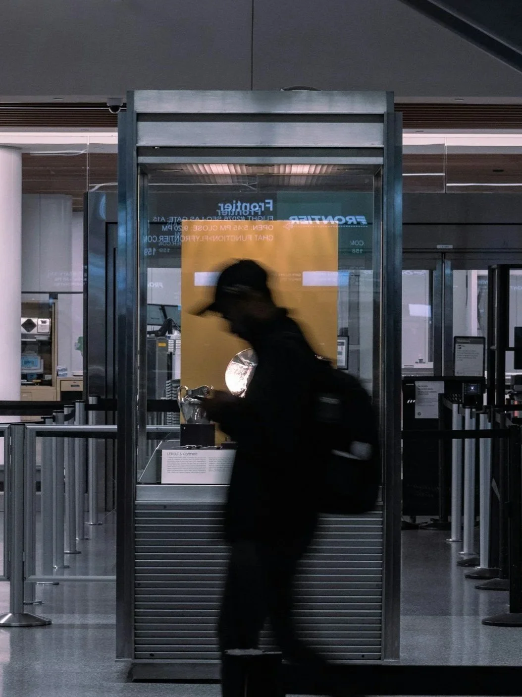 blurred shot of man on phone in train station