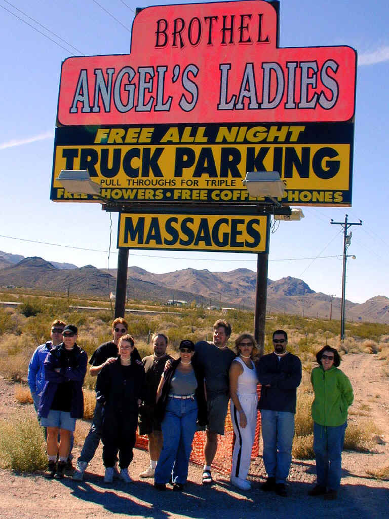 Posing in front of Angel's Ladies brothel sign.