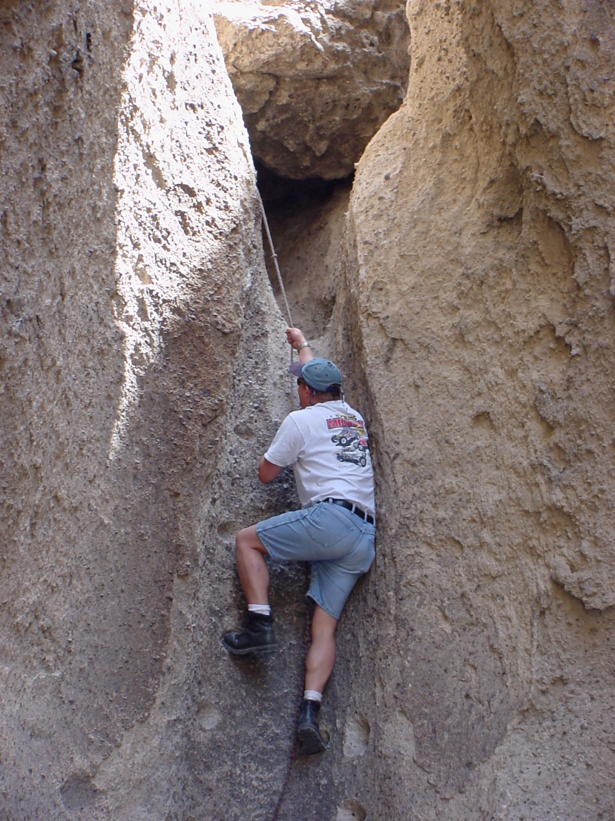 Chris climbs a cliff using nothing but a rope