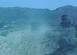 An off road trip as viewed from a following vehicle (notice the dust)