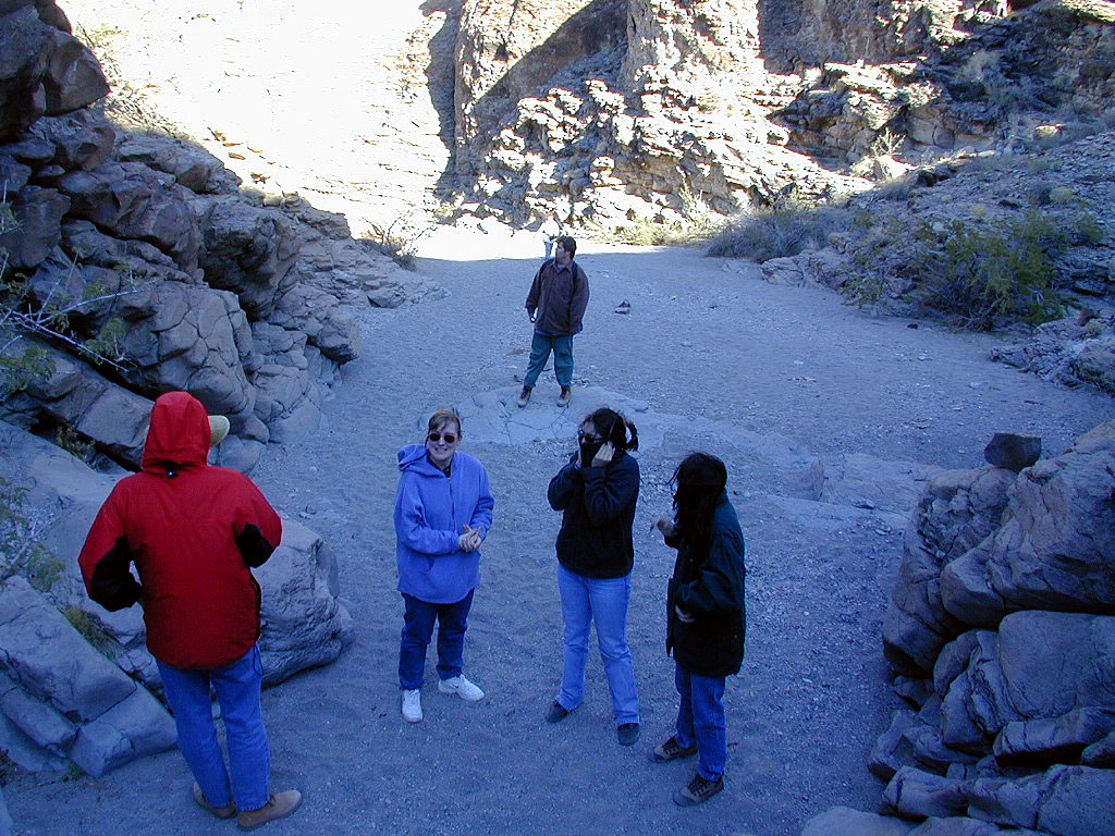 Pausing before climbing the next rock face on the trail to the petroglyphs.