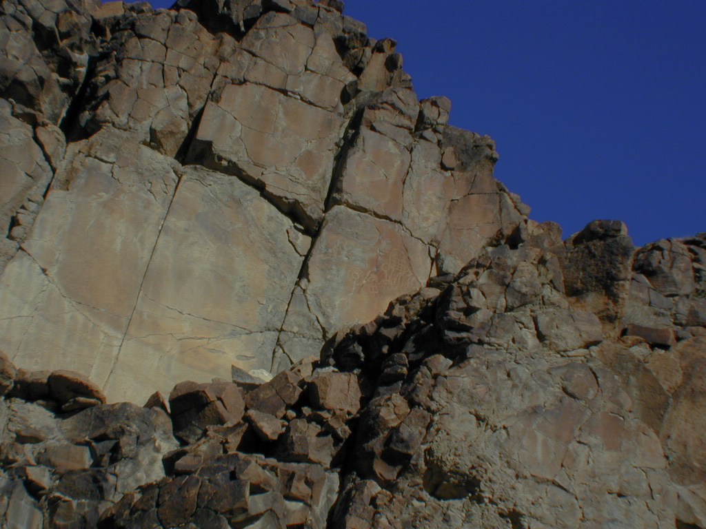 The first petroglyph. It is faint and high up the rock face.