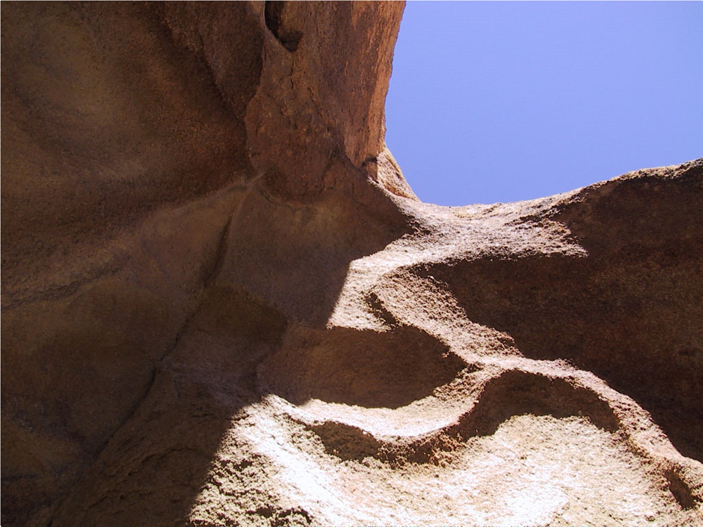 Scalloped depressions in the rocks defied explanation.