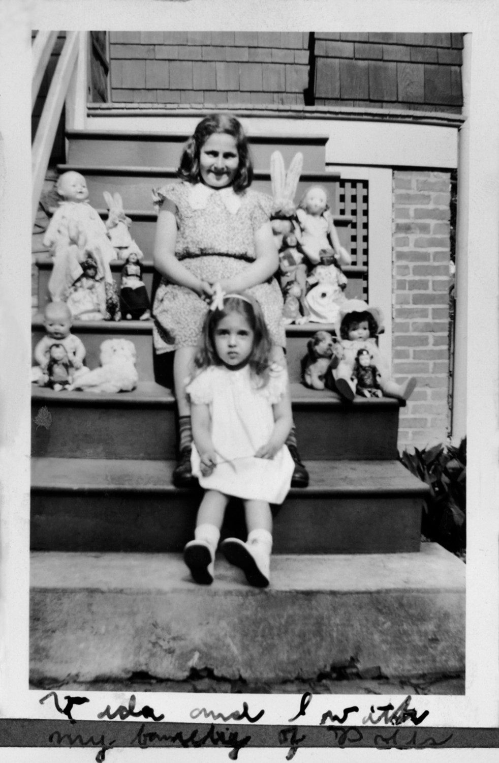 Anne with her cousin Vida and her "family of dolls" (from her photo album)