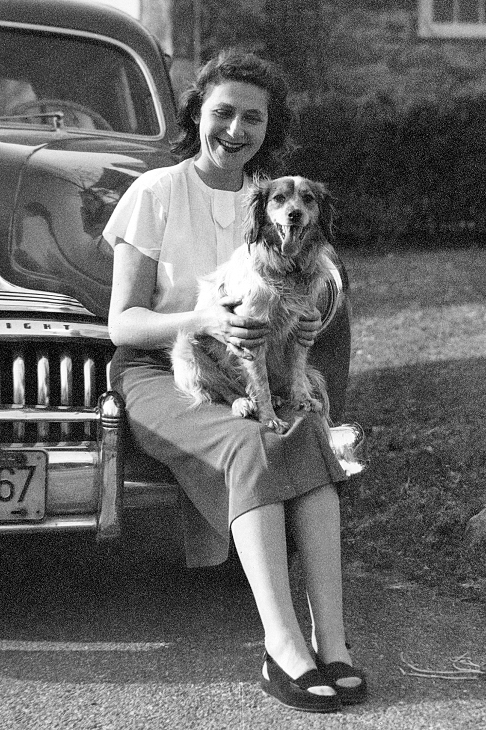 Anne and dog on Eli's Buick Eight