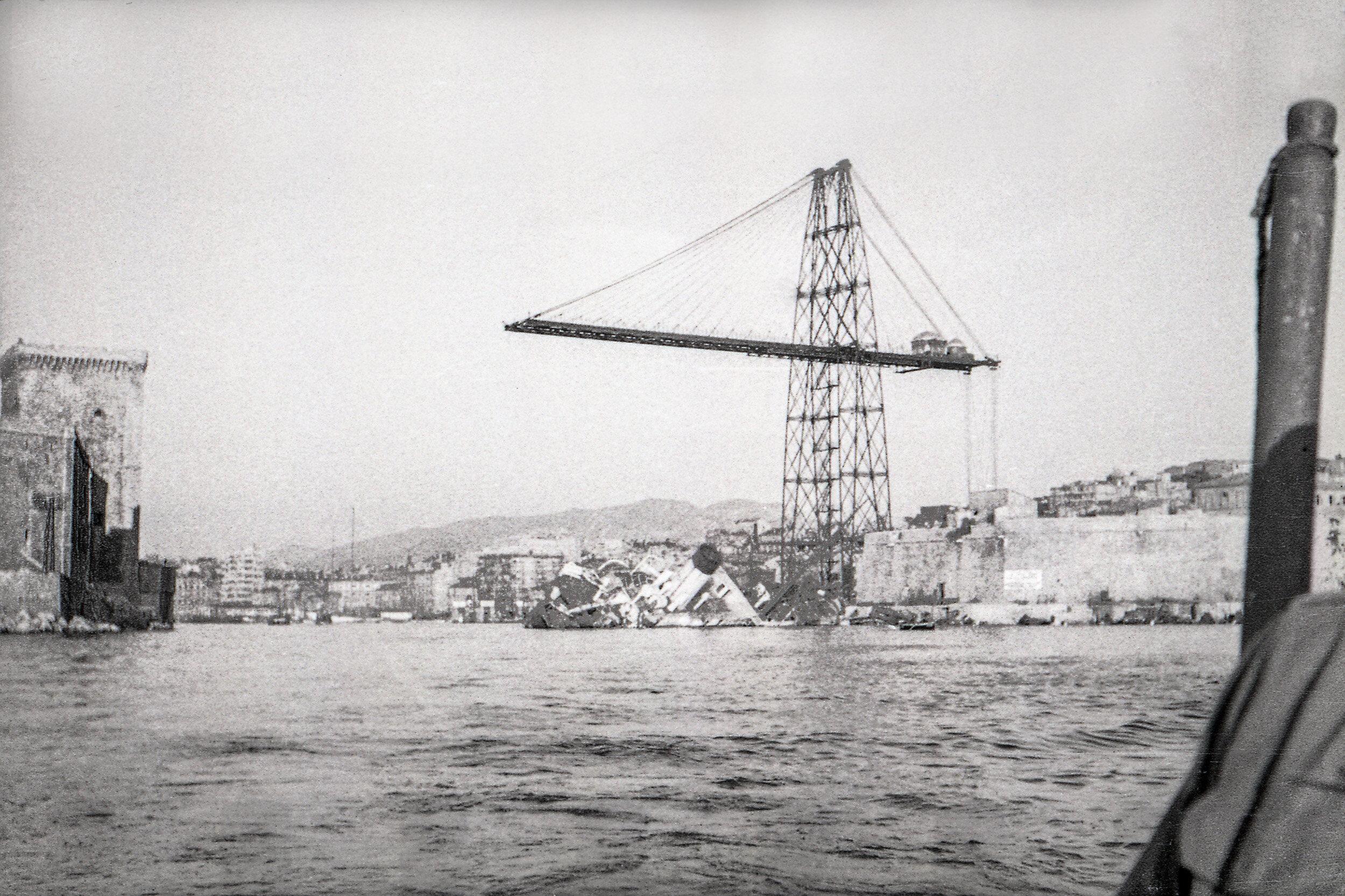 Port of Marseille in WWII, with ship wreckage and remains of the Marseille Transporter Bridge