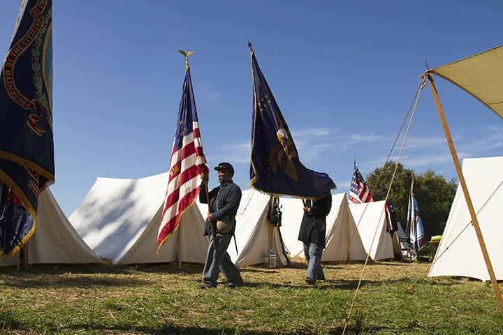 A USCT unit's standard bearers march to formation before the reenactment of the battle of New Market Heights; Henrico County, Virginia, September 2014. Photo: EHP
